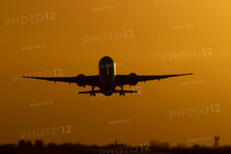 Boeing 777 A7-BFL commercial jet aircraft of Qatar cargo taking off in flight silhouette at sunset at London Stansted airport, Essex, England, United Kingdom