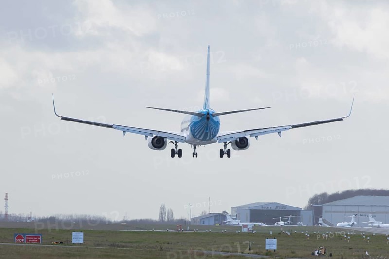 Boeing 737 commercial passenger airliner jet aircraft of Ajet airways in flight on approach to land at London Stansted airport, Essex, England, United Kingdom