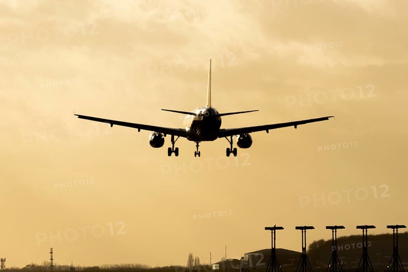 Airbus A320 commercial passenger airliner jet aircraft of Electra airlines flying on approach to land at sunset at London Stansted airport, Essex, England, United Kingdom