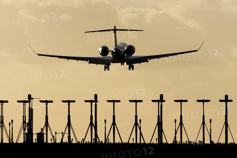 Gulfstream executive business jet aircraft in flight on approach to land at sunset at London Stansted airport, Essex, England, United Kingdom
