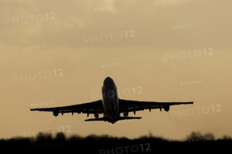 Boeing 747-400 jumbo jet LX-TCV commercial aircraft of Cargolux cargo taking off in flight silhouette at sunset at London Stansted airport, Essex, England, United Kingdom