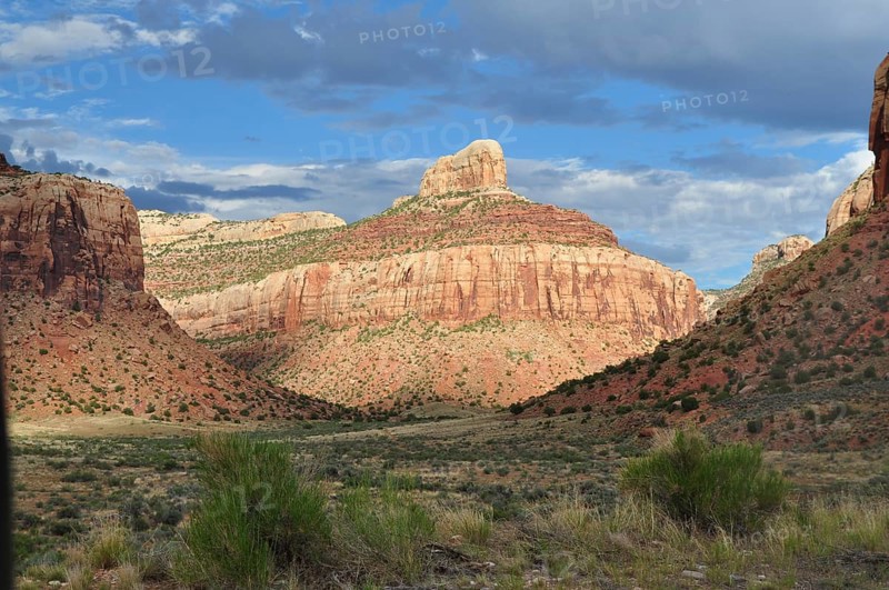 Beautiful rocky landscape under a blue sky with white clouds casting dramatic shadows, Canyonlands National Park, Utah, USA