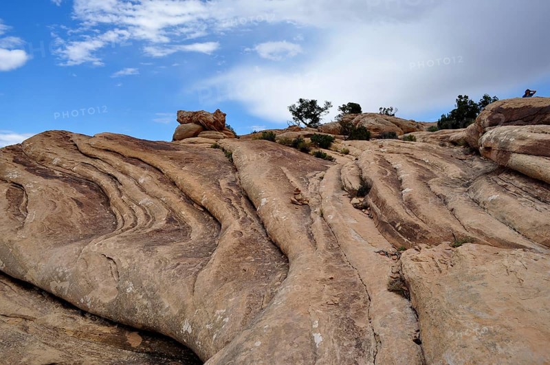 Close-up of curved rock formations under a partly cloudy sky, Canyonlands National Park, Utah, USA