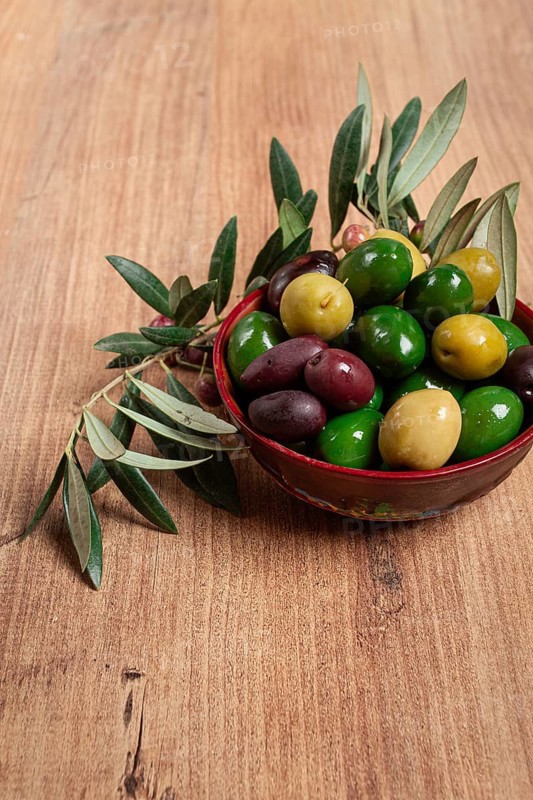 A mixture of olives, varieties of chalkidiki, Verdi giganti and Kalamata, in a bowl, top view, no people