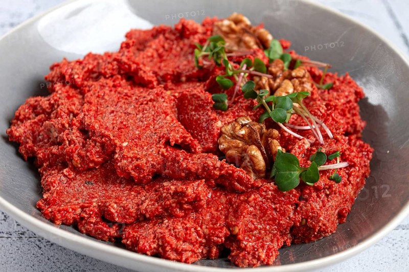 Mahammara red pepper sauce, with walnuts, and sprigs of fresh microgreens, homemade, no people