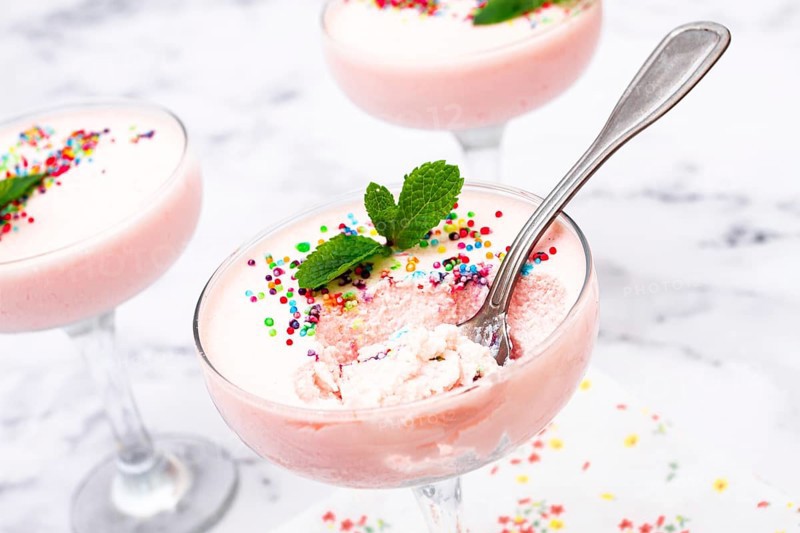 Fruit mousse, made from jelly and cottage cheese, in glasses, decorated with sprinkles and mint, homemade