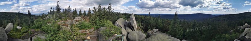 Panoramic view of a mountain landscape with rocks and trees under a dramatic sky, Franconian mountain trail, hiking in the Fichtelgebirge nature park Park