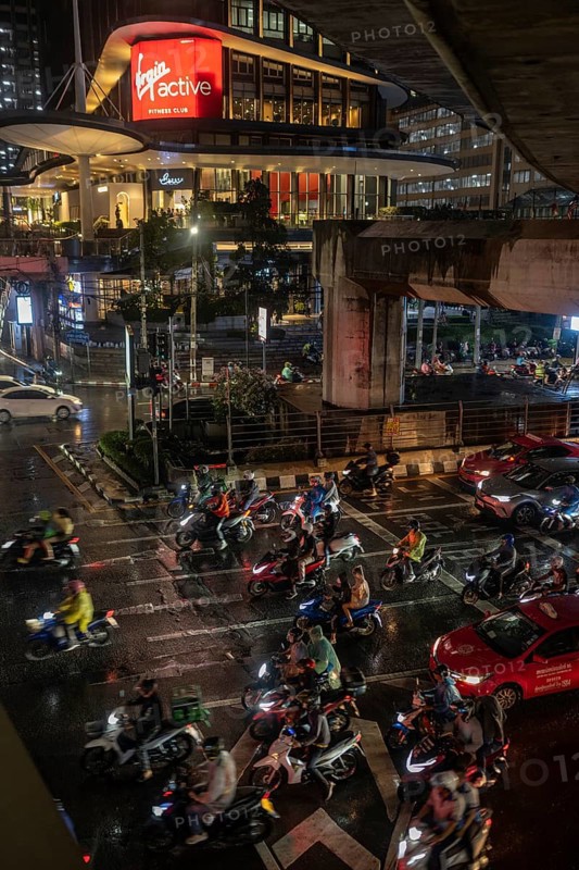 Bangkok, Thailand. March 26th 2025. A busy traffic interchange with lots of motorcycles during wet evening rush hour in Sathon Square, Bangkok, Thailand, Asia