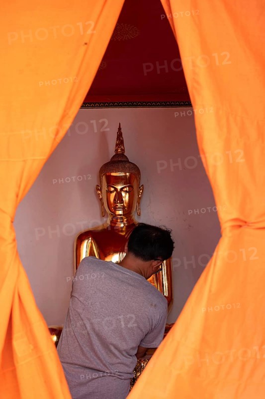 Bangkok, Thailand. March 25th 2025. A golden Buddha image covered in orange cloth in preparation for cleaning at Wat Pho Temple complex known for The Reclining Buddha, Bangkok, Thailand