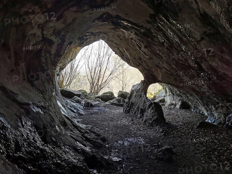View from a mystical cave, with uneven rocks inside, Quack Castle, Franconian Switzerland, Upper Franconia