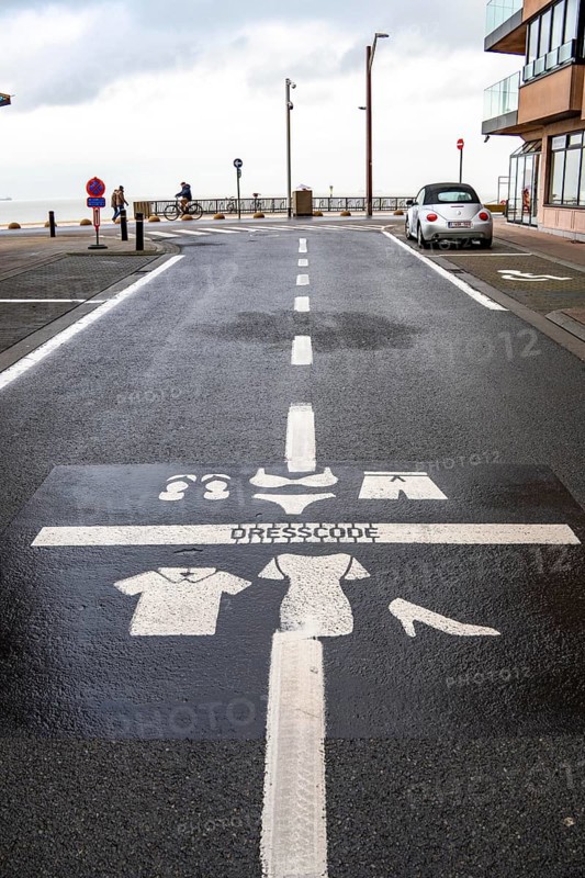 Winter break, on the Zeedijk-Knokke, beach promenade in Knokke-Heist, commandment sign, prohibition sign, for the dress code on the North Sea beach and in the city, painted on the road surface, dreary winter day, Belgium