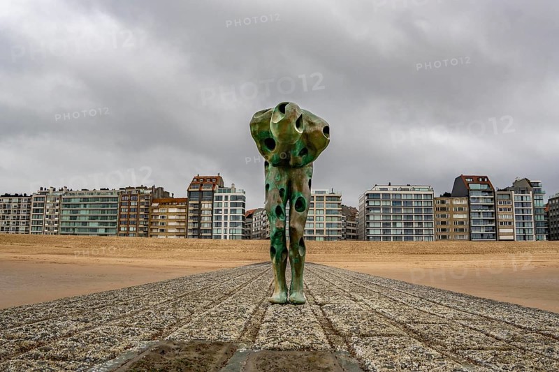 Art on the North Sea beach, in Knokke-Heist, Tomorrow Man by Cathérine François, is washed over by the sea at high tide, many permanent works of art in public spaces are spread around the city, here on the beach on Zeedijk-Knokke, beach promenade, dreary winter day, Belgium