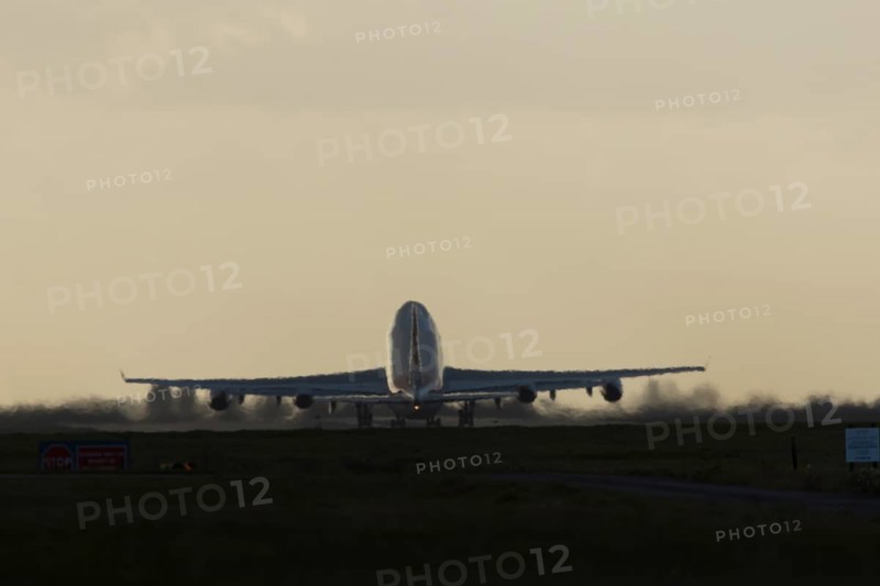 Boeing 747-400 jumbo jet LX-TCV commercial aircraft of Cargolux cargo taking off in flight silhouette at sunset at London Stansted airport, Essex, England, United Kingdom