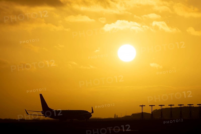 Boeing 737 commercial passenger airliner jet aircraft of Ryanair airlines moving onto the runway to take off at sunset at London Stansted airport, Essex, England, United Kingdom