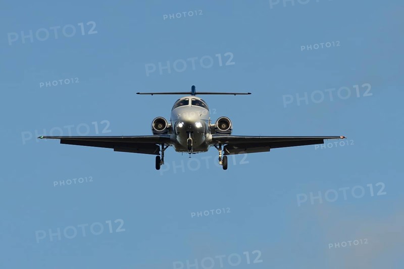 Cessna Citation small executive business jet aircraft in flight on approach to land at London Stansted airport, Essex, England, United Kingdom