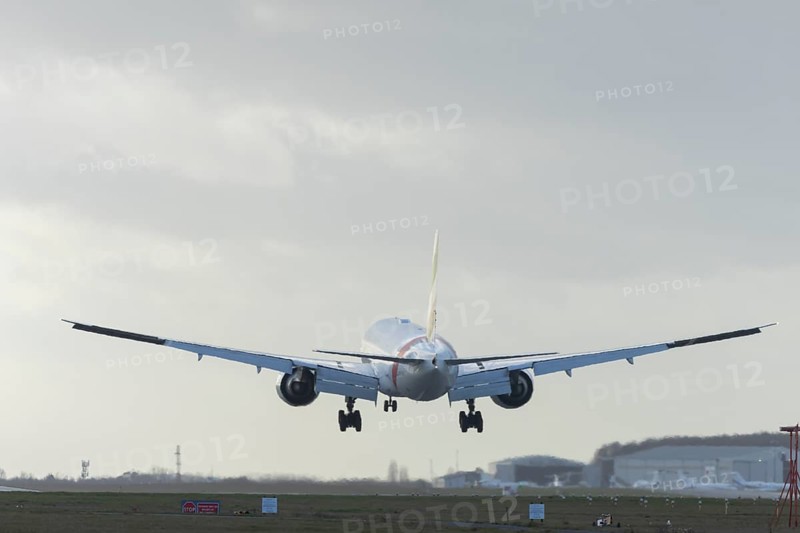 Boeing 777 commercial passenger airliner jet aircraft of Emirates airways landing on the runway at London Stansted airport, Essex, England, United Kingdom