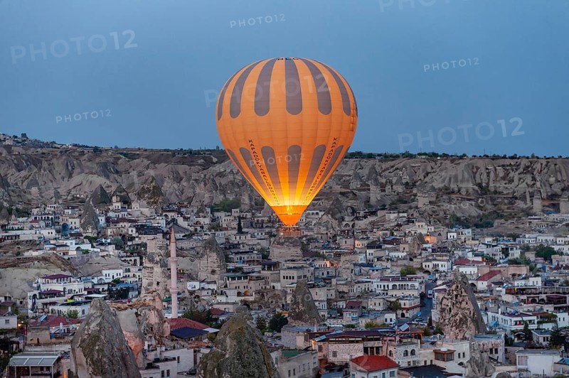 Goreme, Cappadocia. Turkey. October 14th 2018. A hot air balloon flies over the Anatolian village of Goreme in Cappadocia, known for fairy chimneys and cone shaped rocks