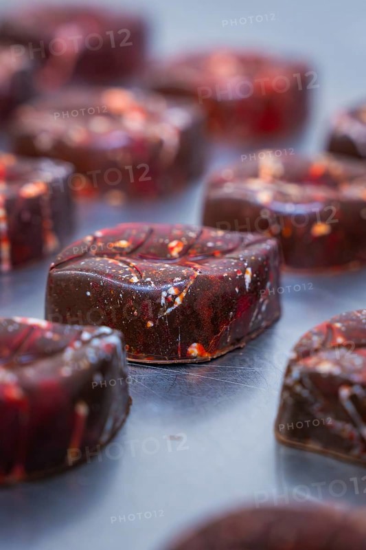 Close-up of a reddish shimmering chocolate with a smooth surface, vegan chocolates production, Haselstaller Hof, Gechingen, Germany