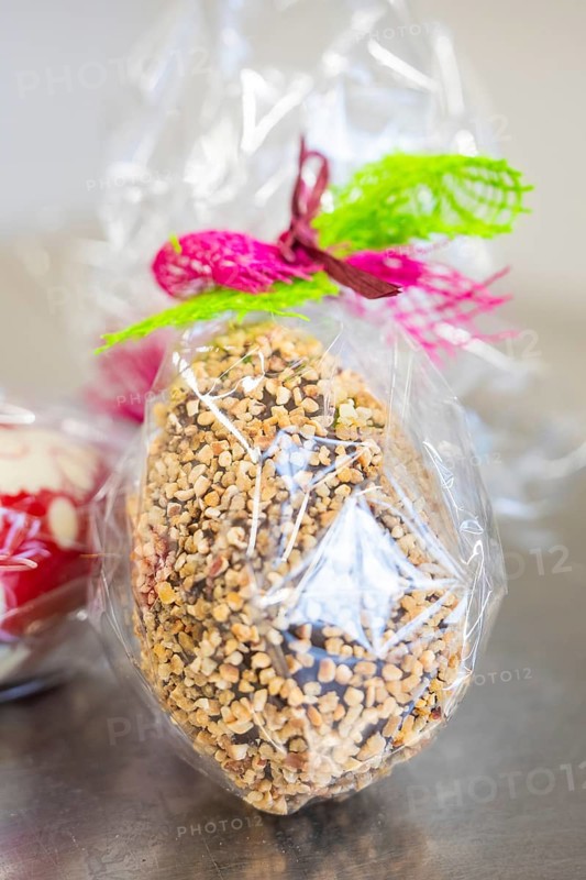 Chocolate decorated with colorful ribbon with nuts in cellophane, Easter production of regional products, Haselstaller Hof, Gechingen, Calw district, Germany
