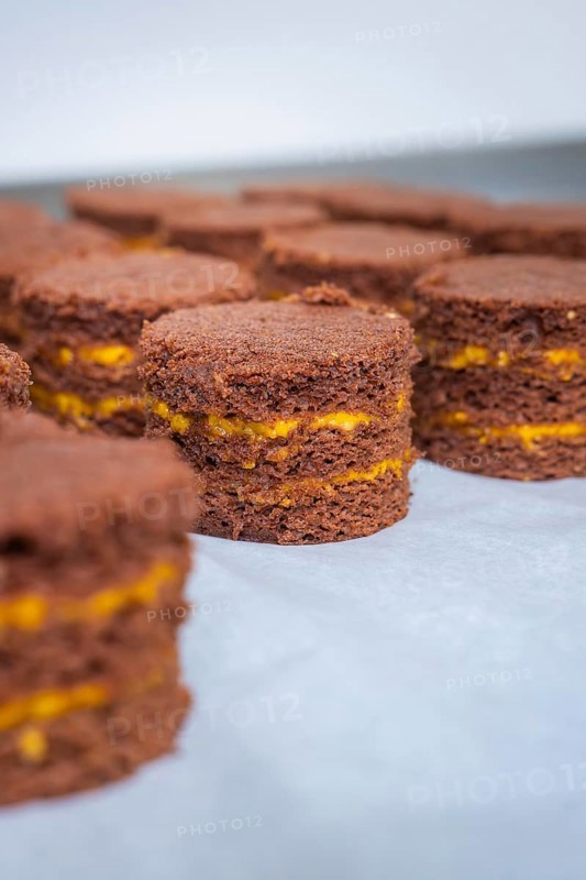 Several chocolate cakes with yellow layers on a tray, vegan cake production, Haselstaller Hof, Gechingen, Germany