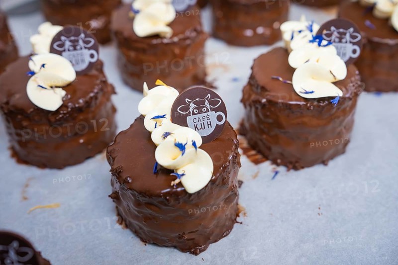 Close-up of chocolate tarts with cream and café logo, vegan cake production, Haselstaller Hof, Gechingen, Germany