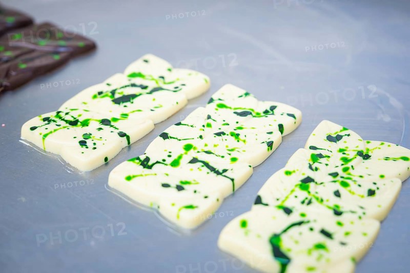 White chocolate bars with green patterns lying side by side on a table, vegan chocolate production, Haselstaller Hof, Gechingen, Germany