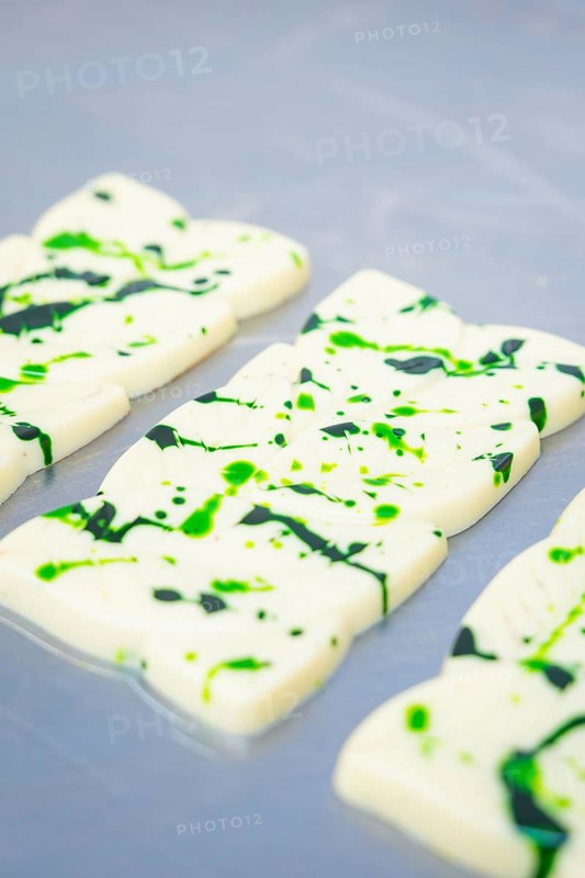 White chocolate bars with green splashes and patterns on a table, vegan chocolate production, Haselstaller Hof, Gechingen, Germany