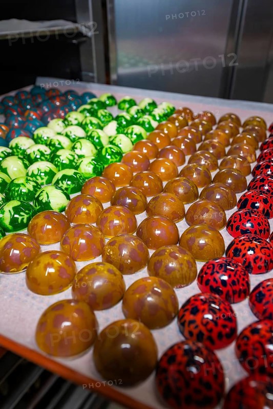 Tray with shiny chocolates in various colors and patterns, Easter production of regional products, Haselstaller Hof, Gechingen, Calw district, Germany