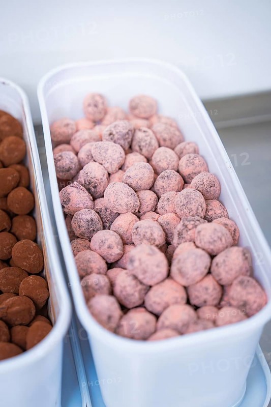 A container full of pink chocolates in a kitchen, chocolate quail eggs, Easter production, Haselstaller Hof, Gechingen, Germany