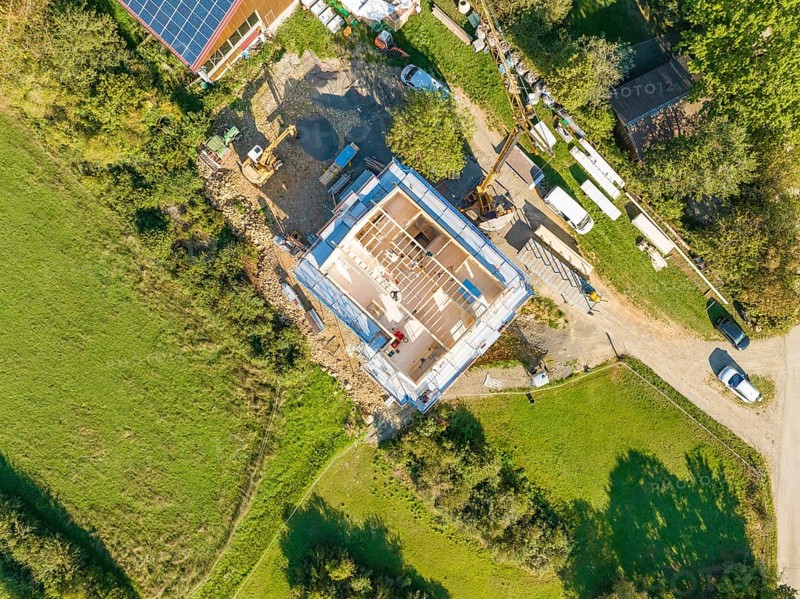 Aerial view of a construction site with grassy areas and an assembled house under construction, timber house construction, Gechingen, Germany