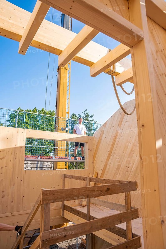 Timber frame construction with a worker on a ladder in sunny weather, timber house construction, Gechingen, Germany