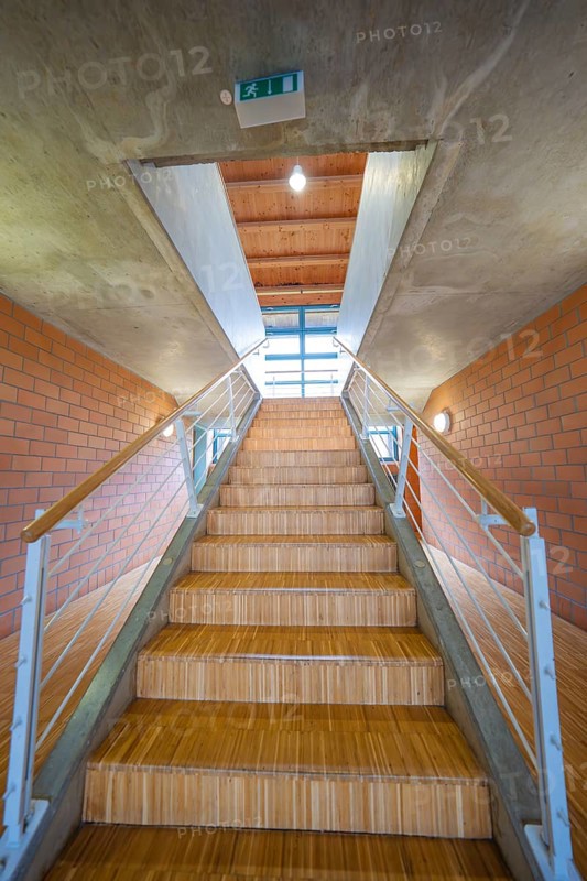 Wooden steps lead up into an open, bright room, Schlehengäu Sporthalle Gechingen, Calw district, Germany