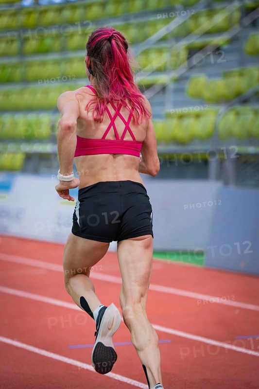 Determined woman running on a running track in a modern hall, middle distance runner Katharina Jaiser, Sindelfingen Glass Palace, Germany