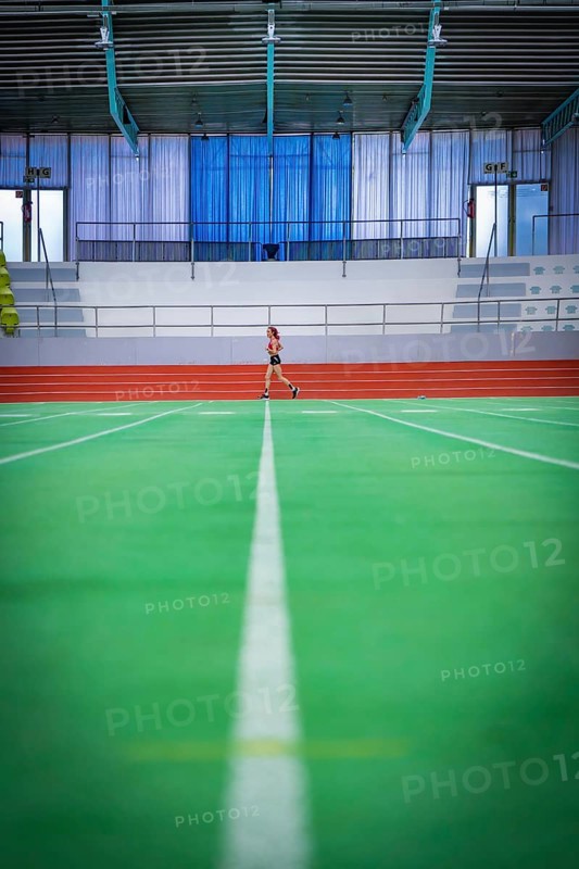 Wide-angle view of an empty track with a person running in the background, middle distance runner Katharina Jaiser, Sindelfingen Glass Palace, Germany