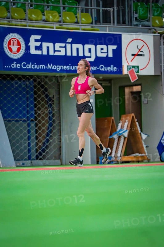 Female athlete running past a banner in a hall, middle distance runner Katharina Jaiser, Sindelfingen Glass Palace, Germany