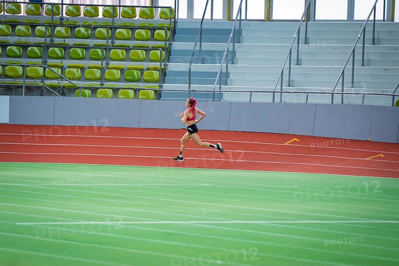 Woman running fast on a red track with strong concentration, middle distance runner Katharina Jaiser, Sindelfingen Glass Palace, Germany
