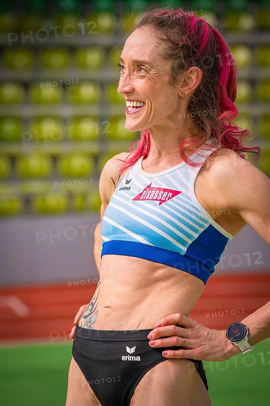Smiling sportswoman with pink hair and tattoo, looks determined in the stadium, middle distance runner Katharina Jaiser, Gechingen, Germany