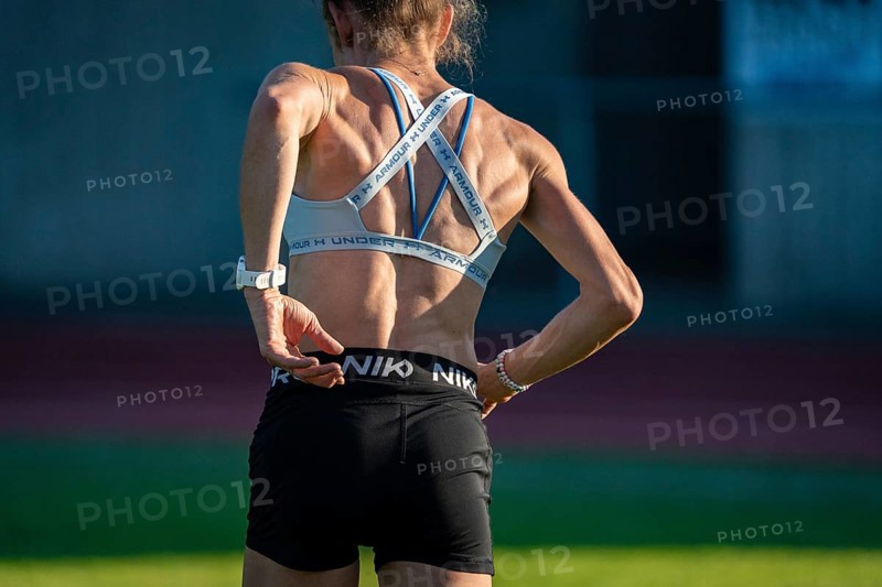 Female athlete taking a break on the running track, back view, relaxed atmosphere, middle distance runner Katharina Jaiser, Gechingen, Germany