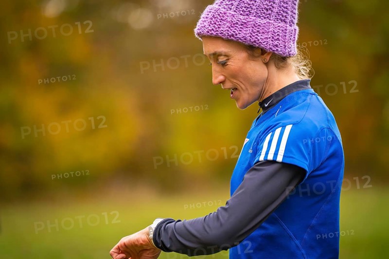 Woman wearing blue sportswear wearing purple cap in autumn setting, middle distance runner Katharina Jaiser, Gechingen, Germany