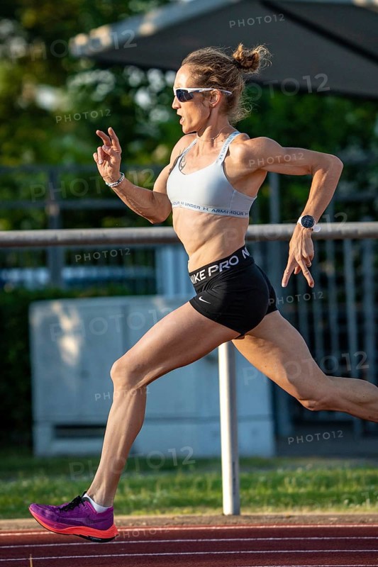 Athlete in full sprint on a running track, with energetic attitude in daylight, middle distance runner Katharina Jaiser, Gechingen, Germany