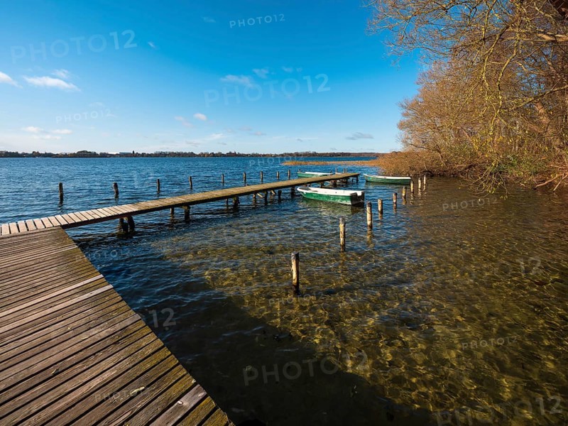 Jetty with rowing boats at Schaalsee in autumn, Schaalsee Biosphere Reserve, Mecklenburg-Western Pomerania Germany