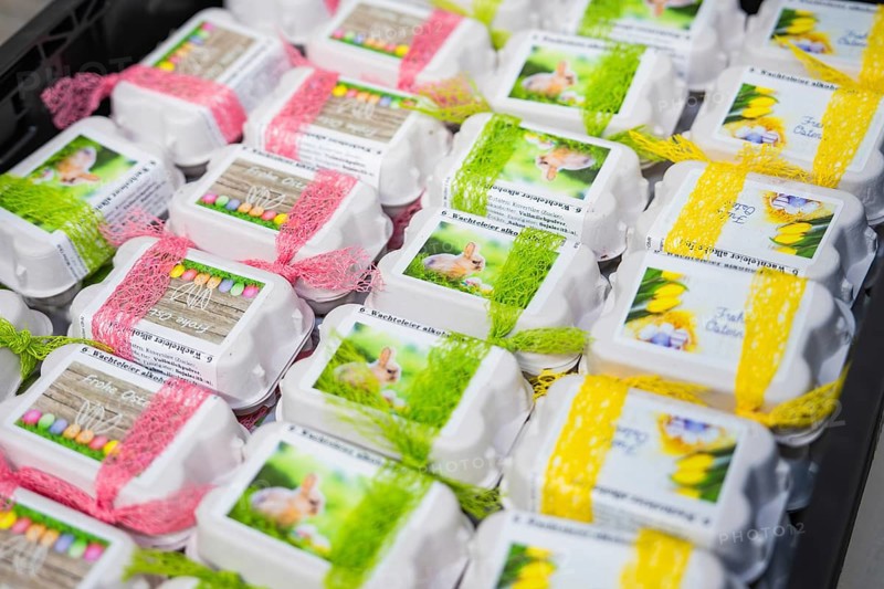 Decorated egg cartons with colorful ribbons and rabbit pictures on them, chocolate quail eggs, Easter production, Haselstaller Hof, Gechingen, Germany