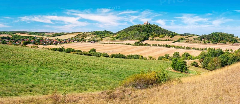 View over hilly landscape with meadows, fields and forests of Wachsenburg Castle and the village of Holzhausen in summer, Burgenensemble Drei Gleichen, Thüringer Burgenland, Thuringian Basin, Thuringia, Germany