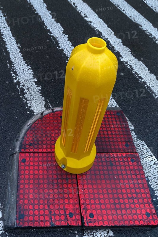 Yellow bollard at a crosswalk, Krakow, Poland