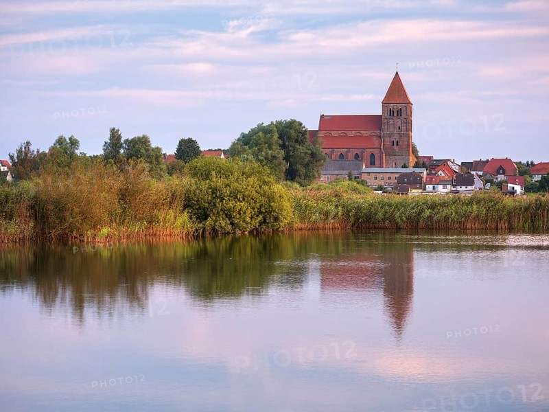 Tribsee with St. Thomas Church in the evening, reflection in a lake, North German brick Gothic, Peenetal River Landscape nature park Park, Mecklenburg-Western Pomerania, Germany