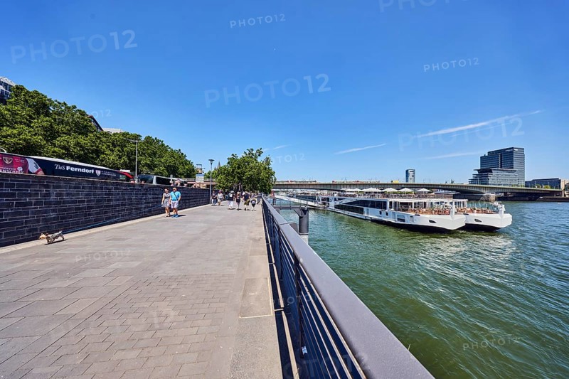 Rhine river, Viking Hlin river cruise ship, Viking Cruises, car bridge and footbridge, waterfront, metal railing, MaxCologne high-rise building, Lanxess, corporate headquarters, pedestrians as accessories, trees, blue sky, cirrus clouds, Leystapelwerft, Cologne, district-free city, North Rhine-Westphalia, Germany