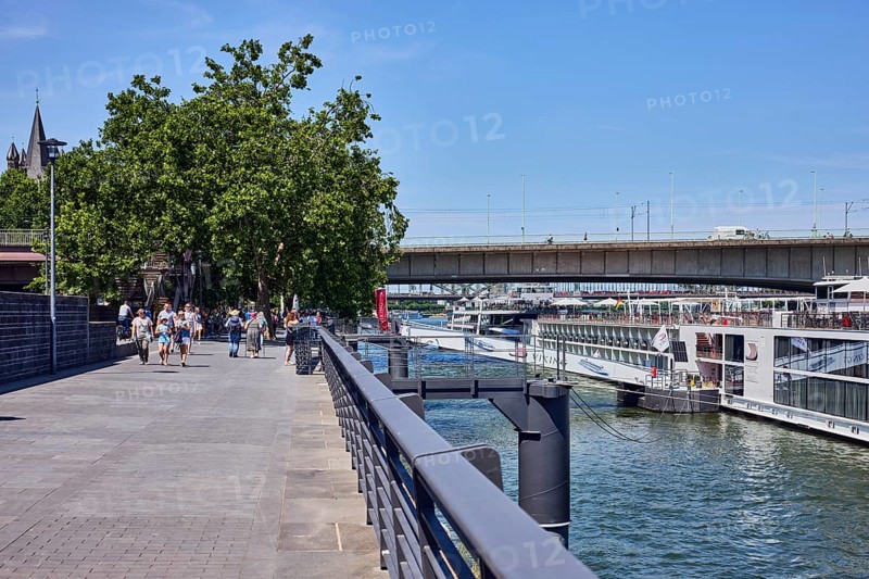 Rhine river, waterfront, metal railing, lantern, ship, gangway, bridge, Deutz bridge, pedestrian as accessories, trees, blue sky, cloudless, Leystapelwerft, Cologne, district-free city, North Rhine-Westphalia, Germany