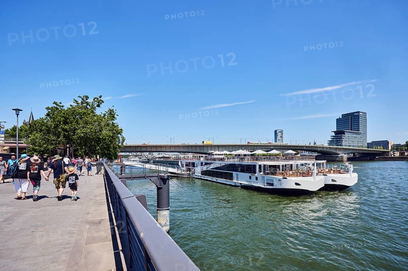 Rhine river, Viking Hlin river cruise ship, Viking Cruises, car bridge and footbridge, waterfront, metal railings, skyscrapers, pedestrians as accessories, trees, blue sky, cirrus clouds, Leystapelwerft, Cologne, district-free city, North Rhine-Westphalia, Germany
