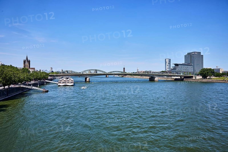 Rhine river, bridge, Deutz bridge, church tower of Groß St. Martin, high-rise MaxCologne, Lanxess, corporate headquarters, sightseeing boats, boat dock, quay wall, trees, blue sky, cloudless, Cologne, district-free city, North Rhine-Westphalia, Germany