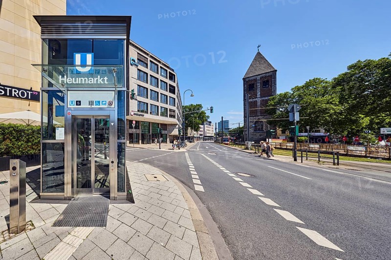 Heumarkt subway stop, church tower of Klein St. Martin, general development, commercial building, modern architecture, sidewalk, pedestrian crossing, cycle path, street, traffic lights, trees, blue sky, cloudless, intersection Kleine Sandkaul, Augustinerstraße and Pipinstraße, Cologne, district-free city, North Rhine-Westphalia, Germany